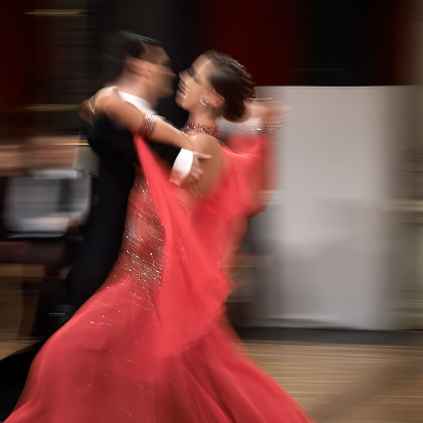 Ein Mann und eine Frau tanzen, die Frau in einem roten Kleid