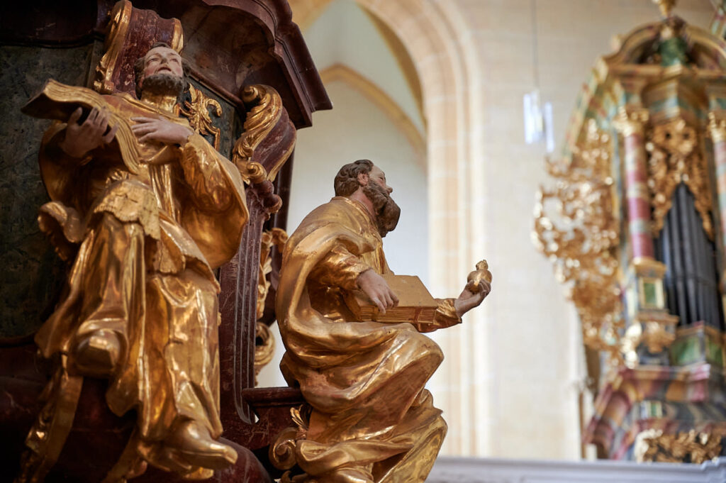a statue of a man holding a book