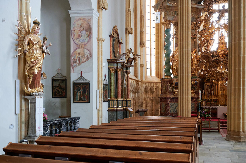 a church with a statue and benches